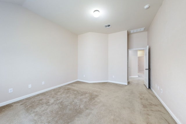 unfurnished room featuring light colored carpet