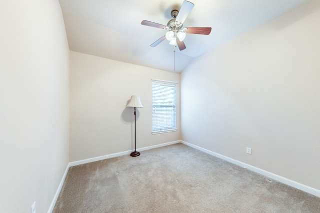 carpeted empty room featuring vaulted ceiling and ceiling fan