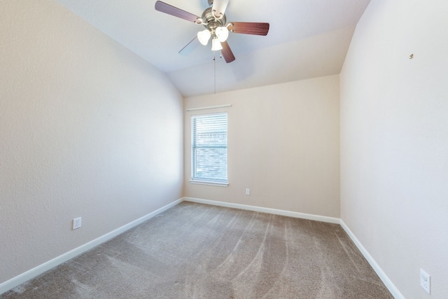 empty room featuring ceiling fan, carpet floors, and lofted ceiling