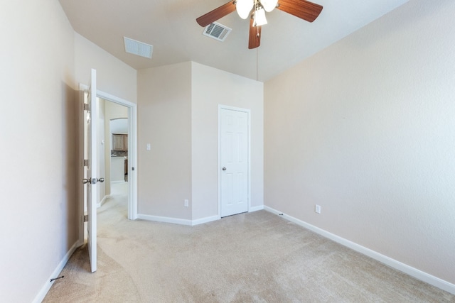 unfurnished bedroom featuring ceiling fan and light colored carpet