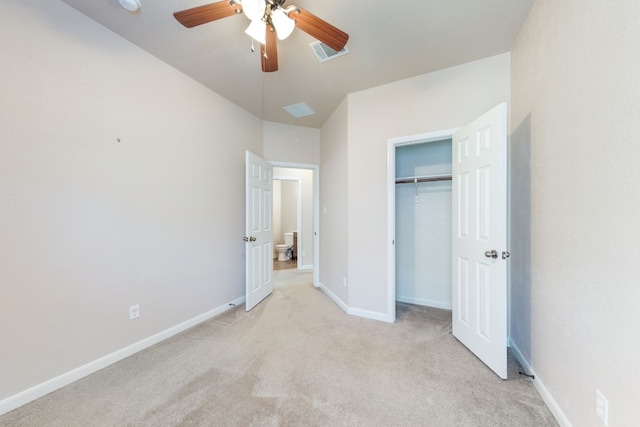 unfurnished bedroom featuring ceiling fan, light carpet, and a closet