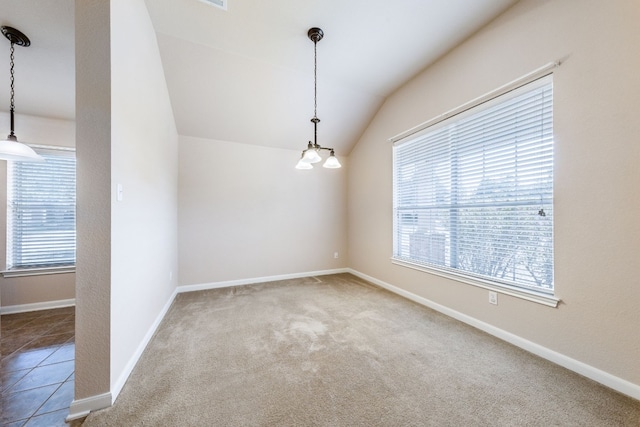 unfurnished room with carpet flooring, a chandelier, and vaulted ceiling