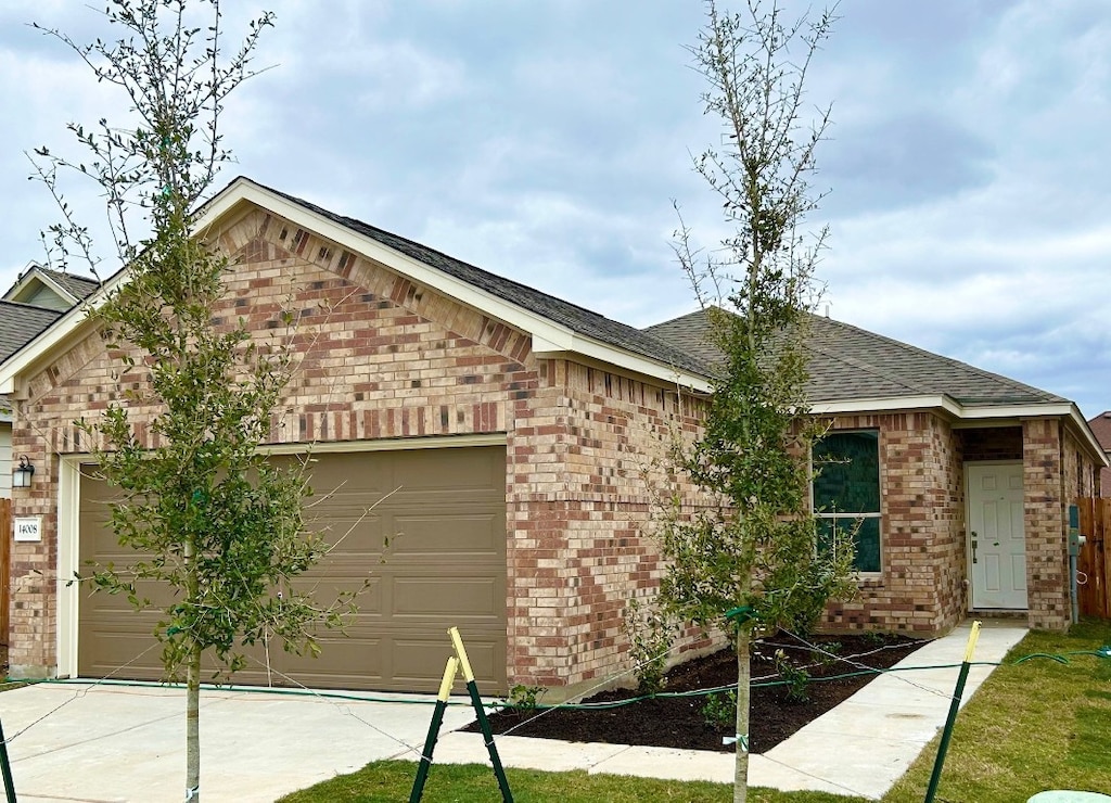 ranch-style home featuring a garage