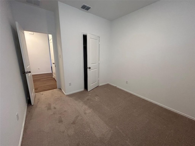 unfurnished bedroom featuring light colored carpet