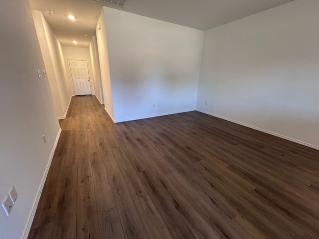 spare room with dark hardwood / wood-style flooring