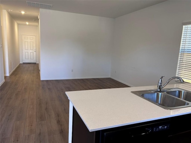 kitchen with dishwasher, dark hardwood / wood-style flooring, and sink