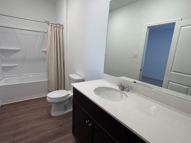 full bathroom featuring shower / bath combo with shower curtain, hardwood / wood-style floors, vanity, and toilet