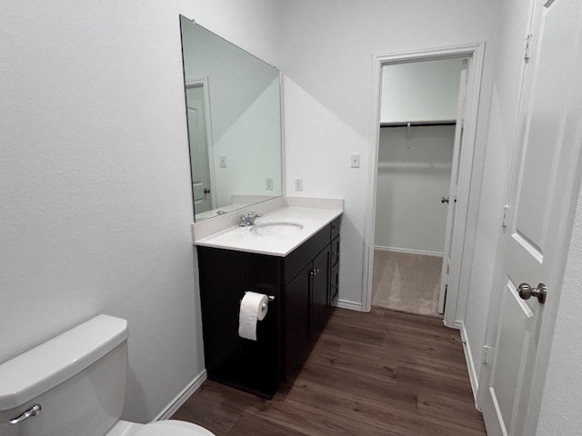 bathroom featuring hardwood / wood-style flooring, vanity, and toilet