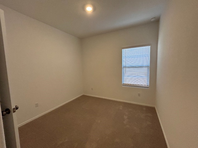 empty room featuring dark carpet