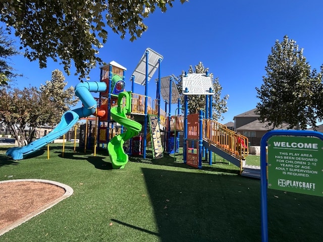 view of playground with a lawn