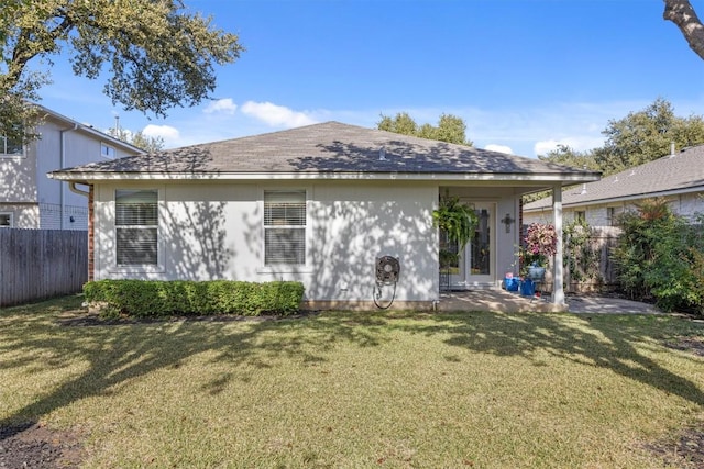 rear view of property with a yard