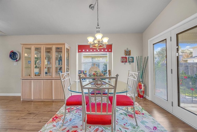 dining area featuring plenty of natural light, a chandelier, and light hardwood / wood-style flooring