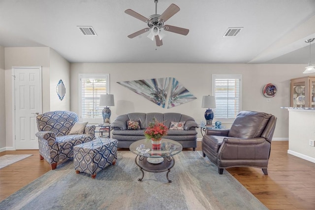 living room with ceiling fan, plenty of natural light, and hardwood / wood-style floors