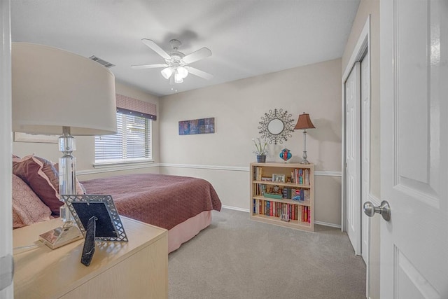 carpeted bedroom with a closet and ceiling fan