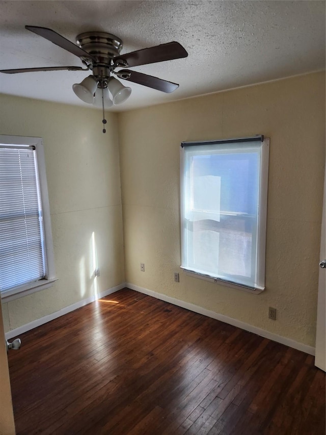 spare room featuring a textured ceiling, dark hardwood / wood-style floors, and ceiling fan