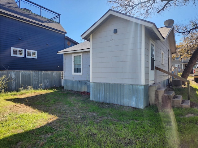 view of property exterior with a lawn