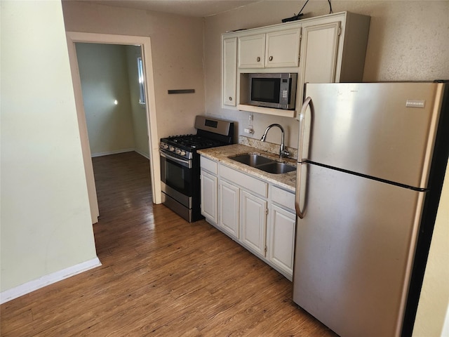 kitchen featuring light hardwood / wood-style floors, sink, white cabinetry, and stainless steel appliances