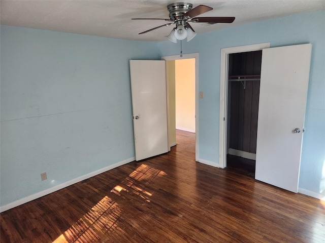 unfurnished bedroom featuring a closet, ceiling fan, and dark hardwood / wood-style flooring