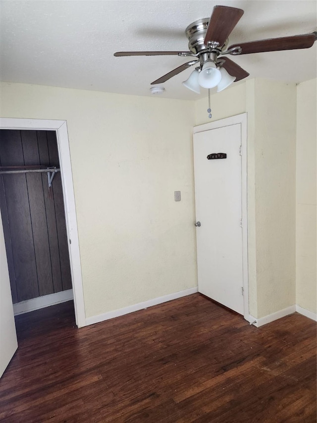 entrance foyer featuring ceiling fan and dark wood-type flooring