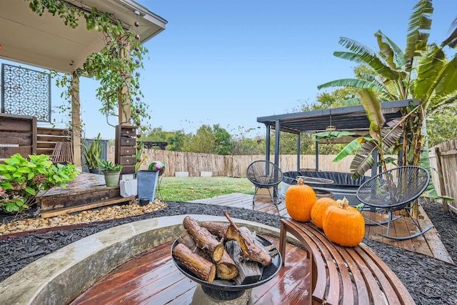 wooden terrace featuring a fire pit