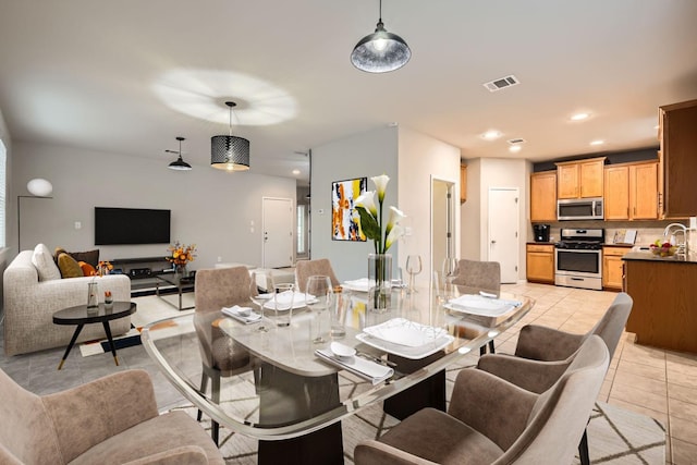 dining space with sink and light tile patterned floors