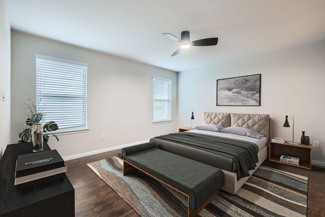 bedroom with dark hardwood / wood-style flooring and ceiling fan