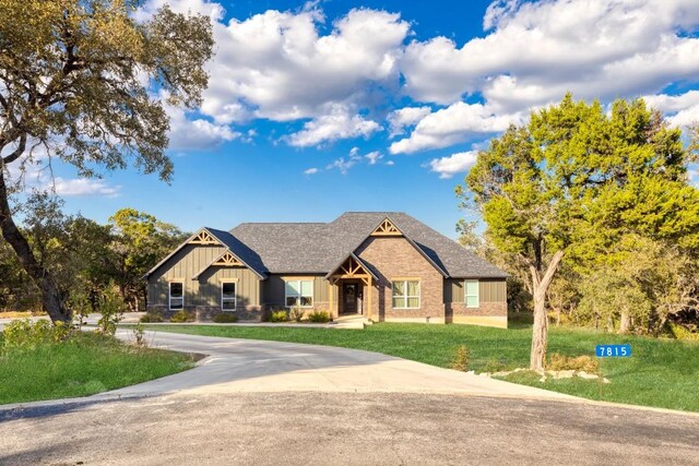 craftsman inspired home with a front lawn