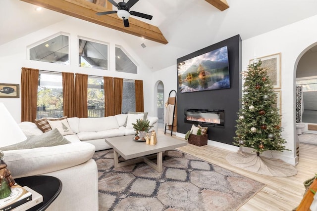 living room featuring high vaulted ceiling, beam ceiling, ceiling fan, and hardwood / wood-style floors