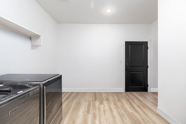 laundry room featuring light hardwood / wood-style flooring and washer and clothes dryer