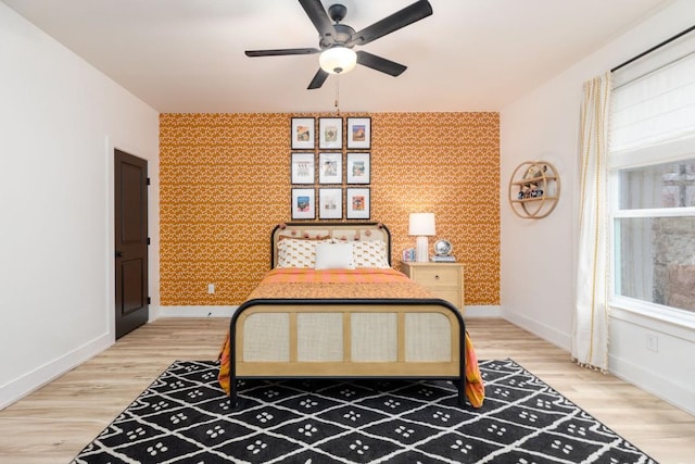 bedroom with hardwood / wood-style floors and ceiling fan