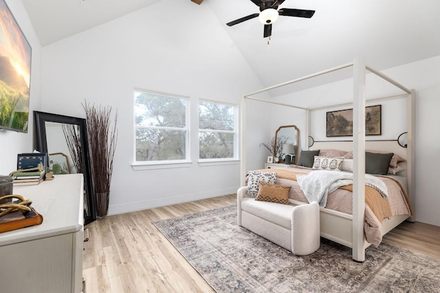 bedroom featuring ceiling fan, light wood-type flooring, high vaulted ceiling, and beamed ceiling