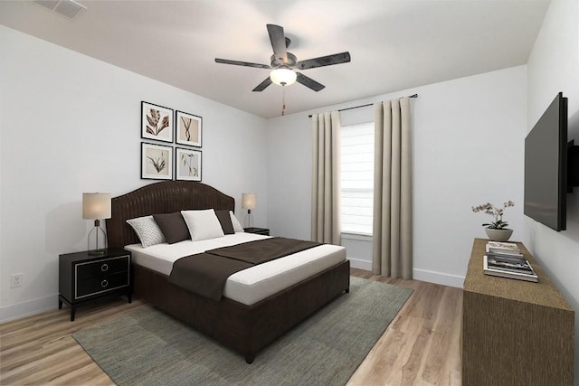 bedroom with ceiling fan and light hardwood / wood-style floors