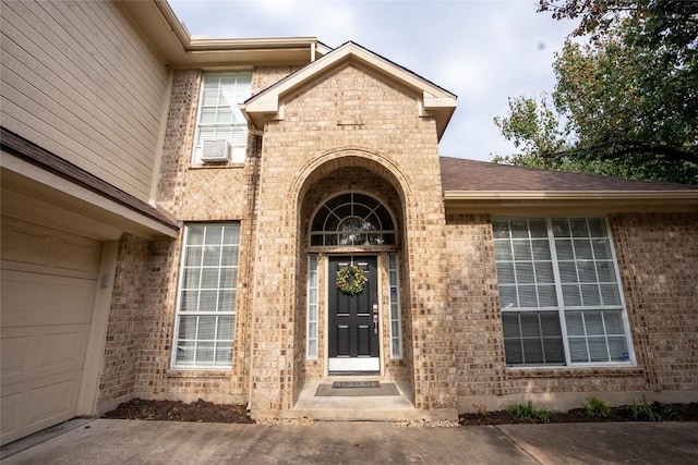 doorway to property with a garage