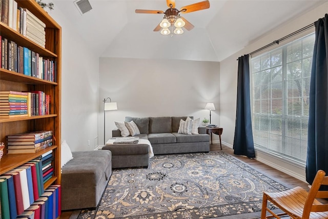 living room with hardwood / wood-style flooring, vaulted ceiling, and ceiling fan