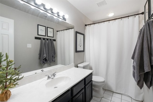 bathroom featuring tile patterned flooring, vanity, and toilet