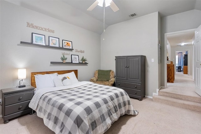 bedroom with ceiling fan, light carpet, and vaulted ceiling