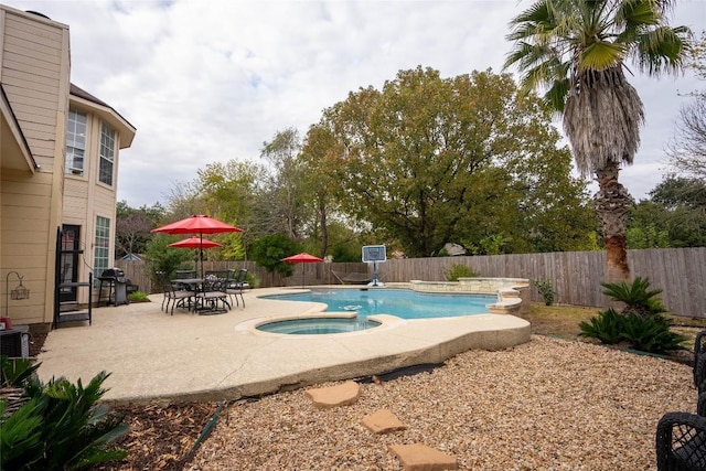 view of pool with a patio area and an in ground hot tub