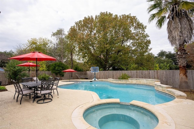 view of pool with an in ground hot tub and a patio