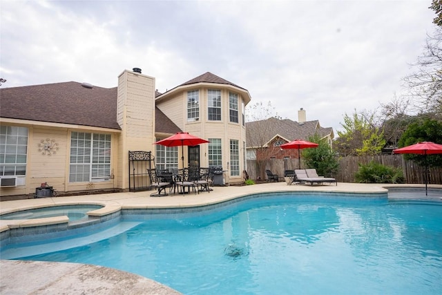 view of pool featuring grilling area, an in ground hot tub, and a patio