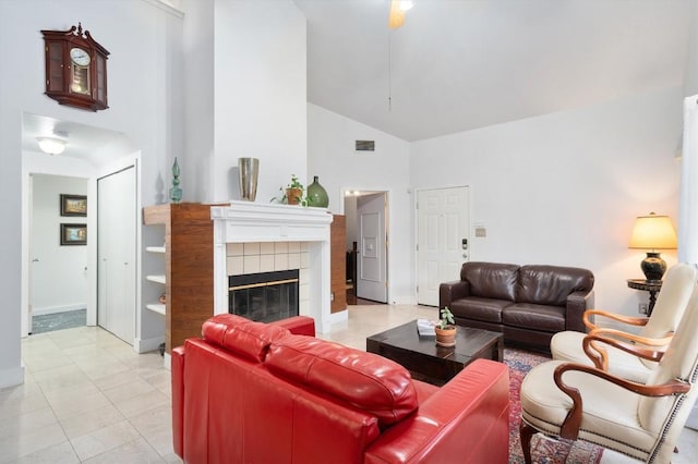 12809 Meehan Dr, Austin, TX 78727 - living room with high vaulted ceiling, a tile fireplace, and tile patterned floors