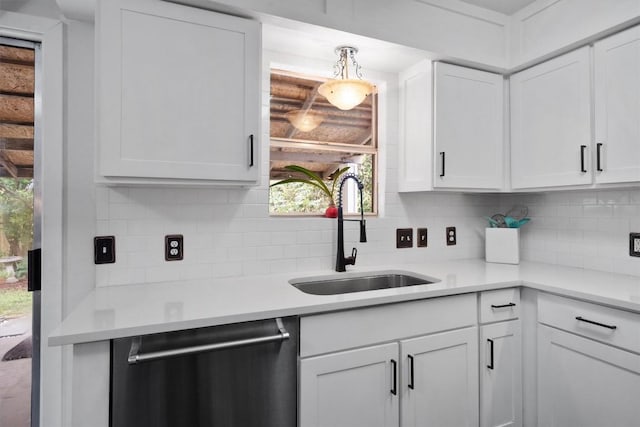 12809 Meehan Dr, Austin, TX 78727 - kitchen featuring stainless steel dishwasher, backsplash, white cabinets, and light countertops