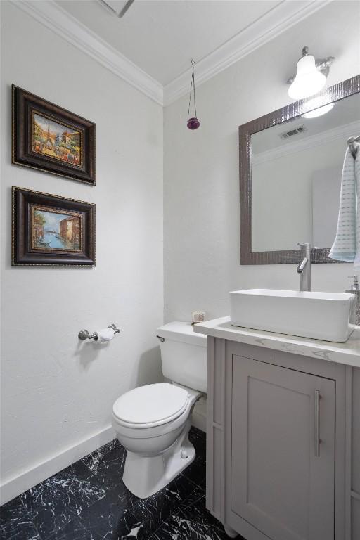 12809 Meehan Dr, Austin, TX 78727 - half bath featuring vanity, ornamental molding, and marble finish flooring