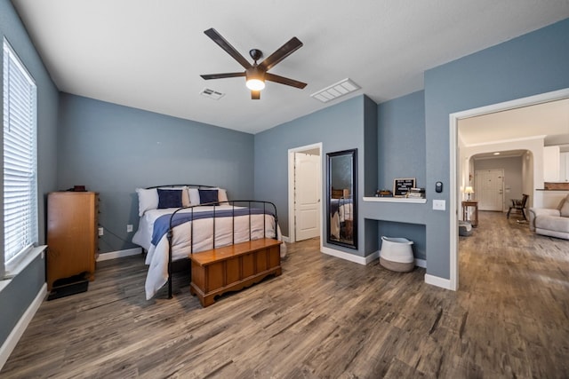 bedroom featuring multiple windows, ceiling fan, and dark wood-type flooring