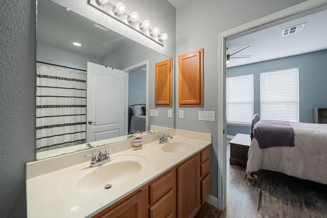 bathroom with ceiling fan, vanity, and wood-type flooring