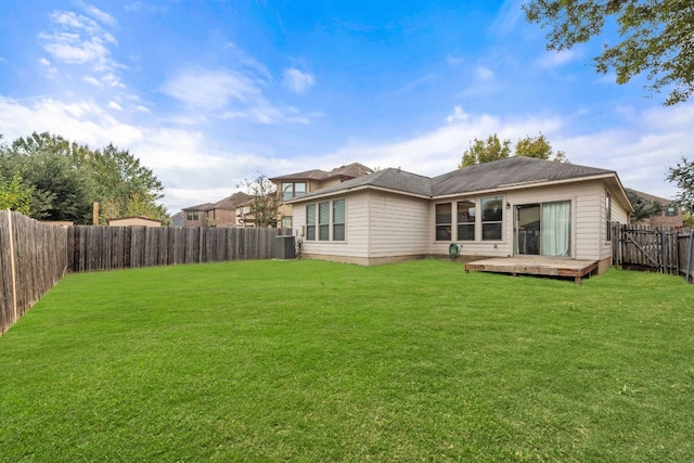 back of house with a lawn, a deck, and central air condition unit