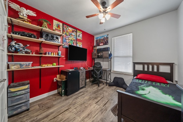 bedroom with ceiling fan and hardwood / wood-style flooring