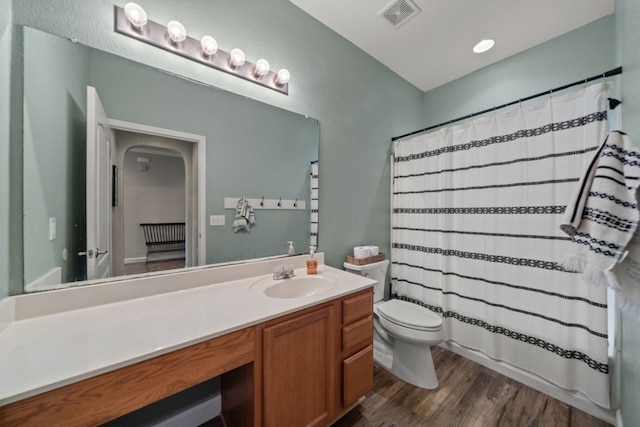 bathroom featuring hardwood / wood-style floors, vanity, and toilet