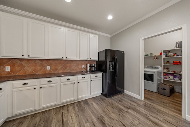 kitchen featuring white cabinets, washer / clothes dryer, light wood-type flooring, and black refrigerator with ice dispenser