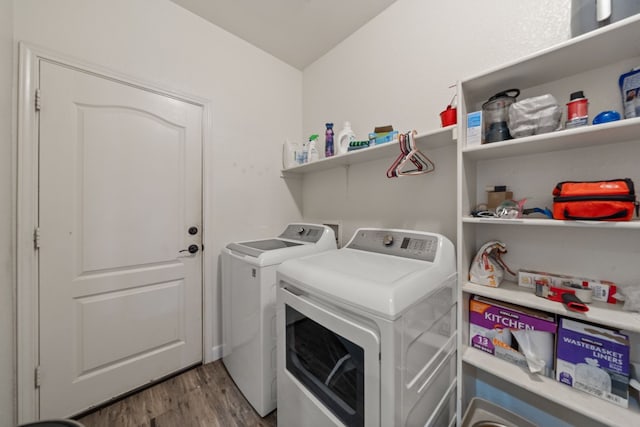 washroom with washer and dryer and light wood-type flooring