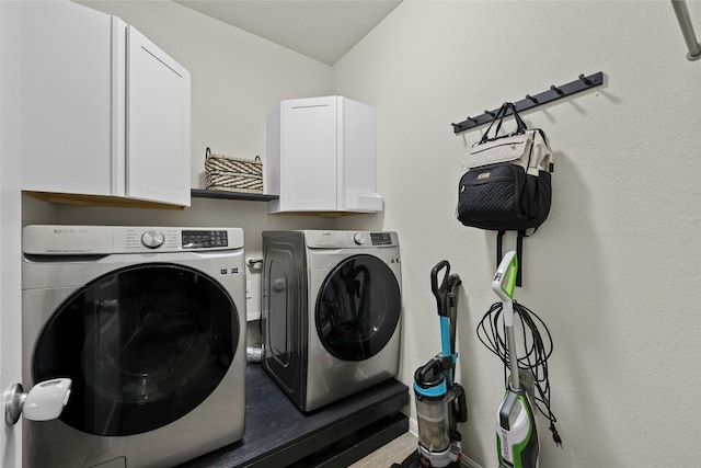 laundry area with cabinets and washing machine and dryer